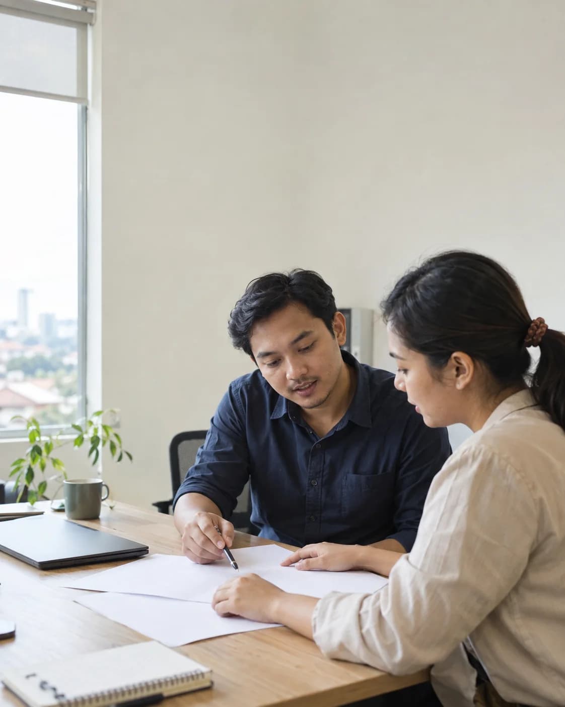 Illustrative photo of two people discussing business needs and documents